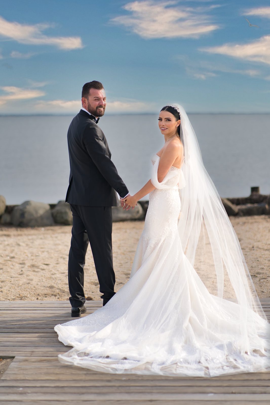 Bride and groom on a Long Island beach boardwalk