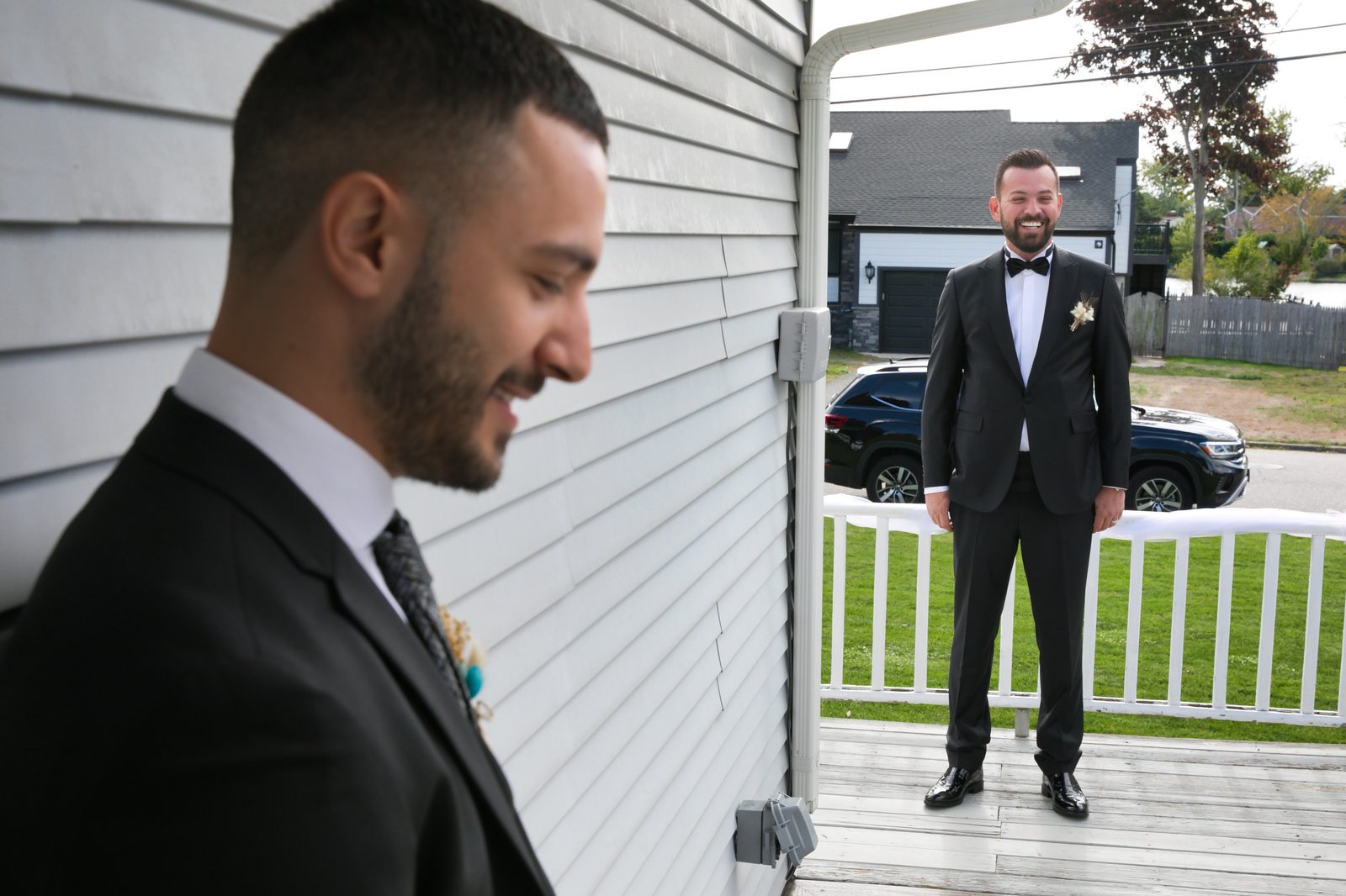 Groom smiling on the porch