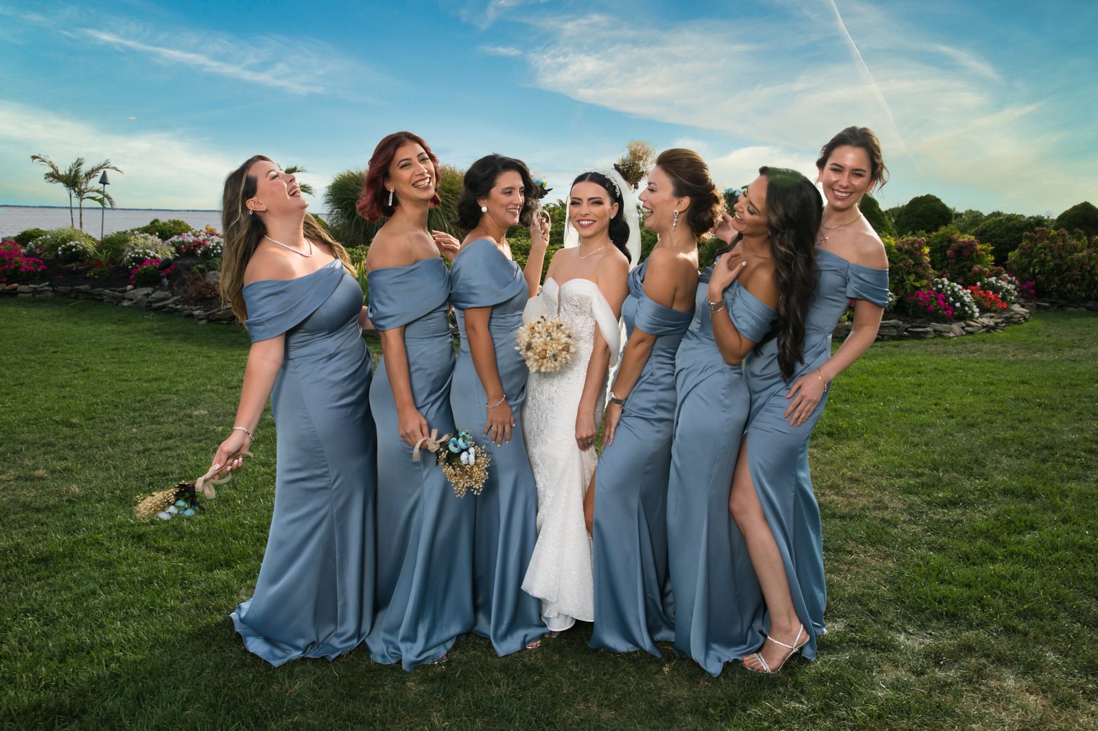 Bride laughing with bridesmaids in blue dresses