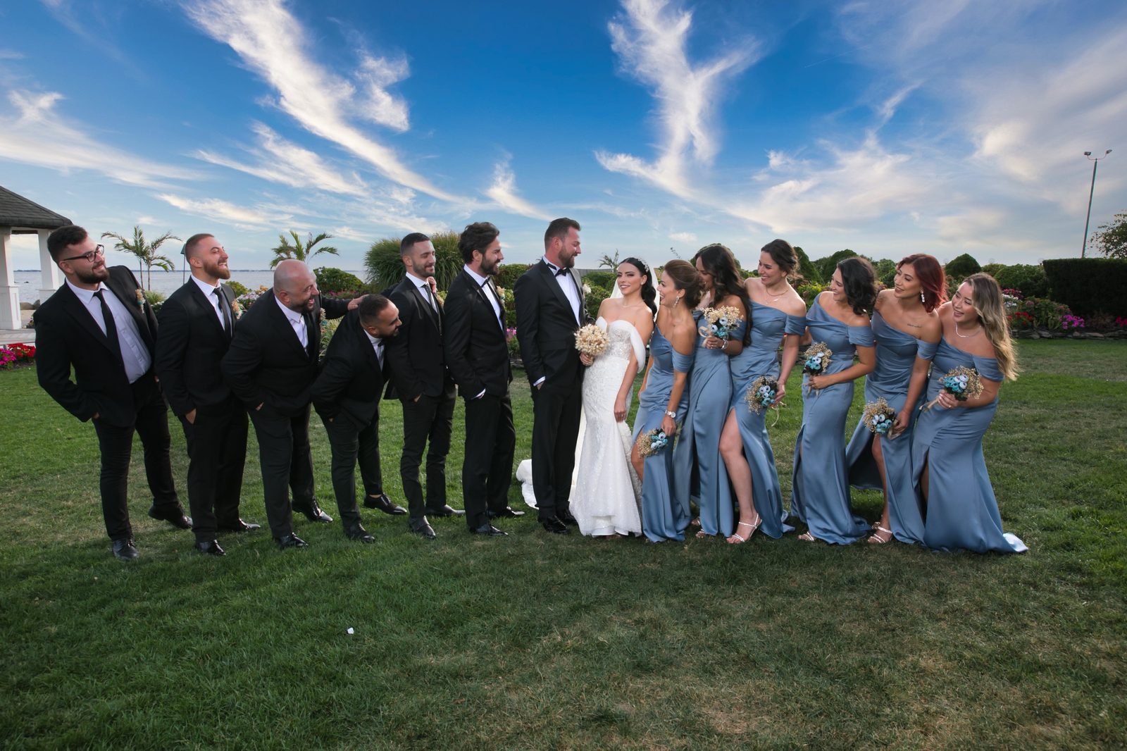 Bridal party laughing on the lawn